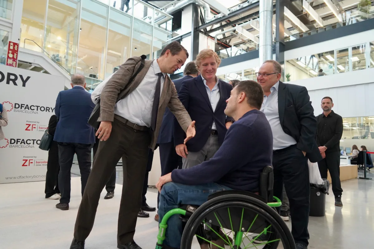 Wheelchair user talking with attendees at DFactory Barcelona